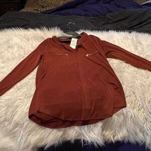 INC. deep maroon top.